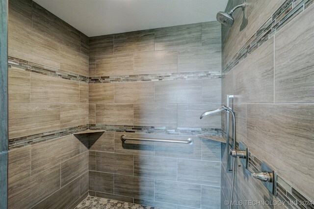 bathroom with a tile shower