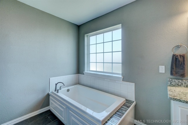 bathroom featuring vanity, a bathtub, and tile patterned flooring