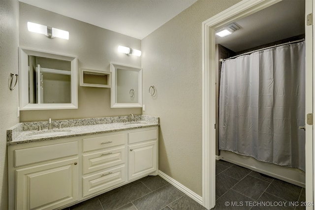 bathroom featuring vanity, shower / bath combination with curtain, and tile patterned flooring