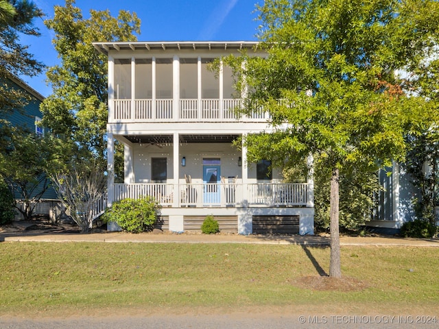 view of front of property with a front lawn and a sunroom