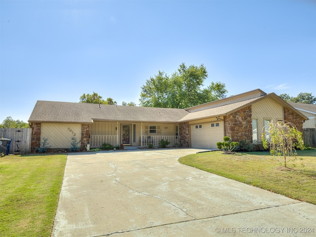 ranch-style house with a front yard and a garage