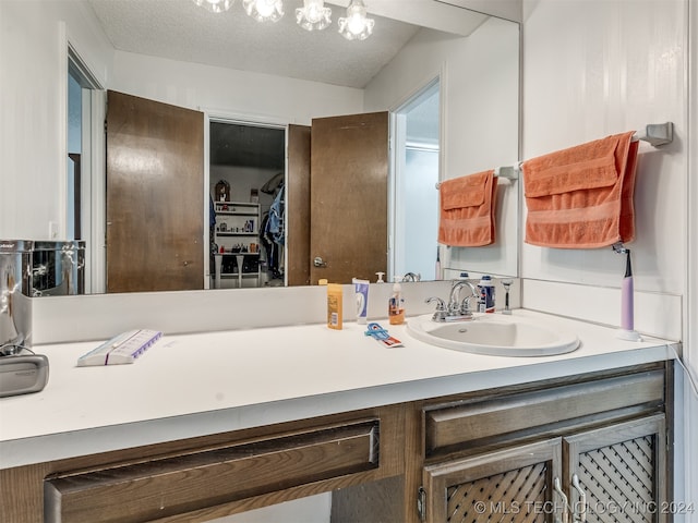 bathroom featuring vanity and a textured ceiling