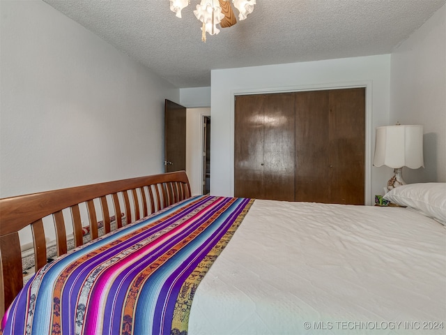 bedroom with a closet and a textured ceiling