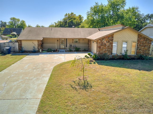 ranch-style house with a front yard and a garage