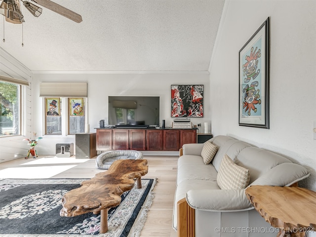 living room featuring crown molding, a textured ceiling, light hardwood / wood-style floors, and ceiling fan