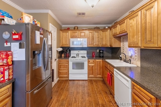 kitchen featuring decorative backsplash, light wood-type flooring, ornamental molding, sink, and white appliances