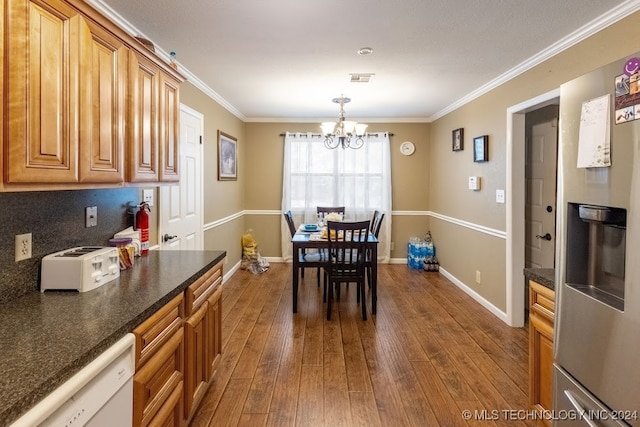 dining space featuring a notable chandelier, ornamental molding, and dark hardwood / wood-style flooring