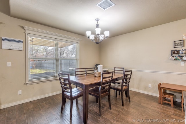 dining room featuring baseboards, visible vents, dark wood-style floors, and an inviting chandelier