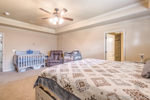 carpeted bedroom featuring ceiling fan, visible vents, ornamental molding, and a raised ceiling