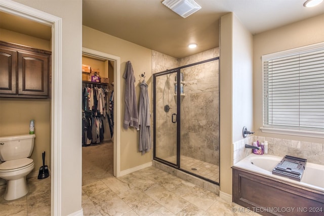 bathroom featuring a walk in closet, a bath, visible vents, a stall shower, and toilet