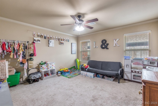 recreation room with crown molding, carpet flooring, and ceiling fan