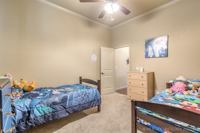 carpeted bedroom featuring ornamental molding and a ceiling fan