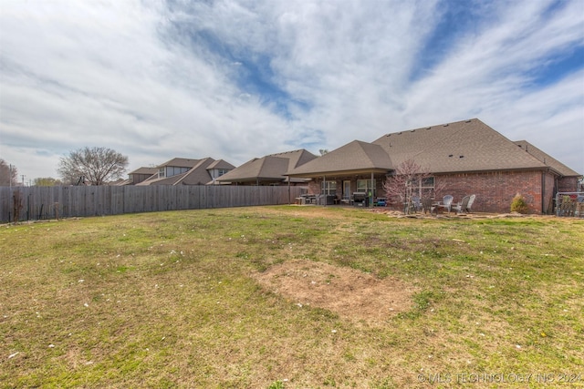 view of yard featuring a patio and fence