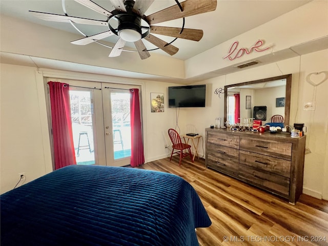 bedroom with french doors, ceiling fan, access to exterior, and hardwood / wood-style flooring