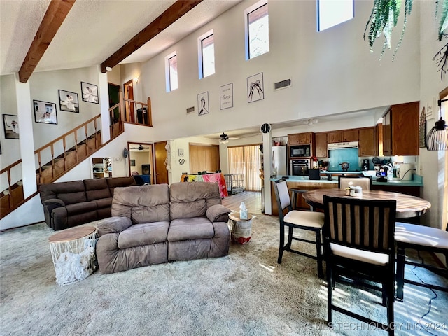 living room featuring beam ceiling, light carpet, high vaulted ceiling, and ceiling fan