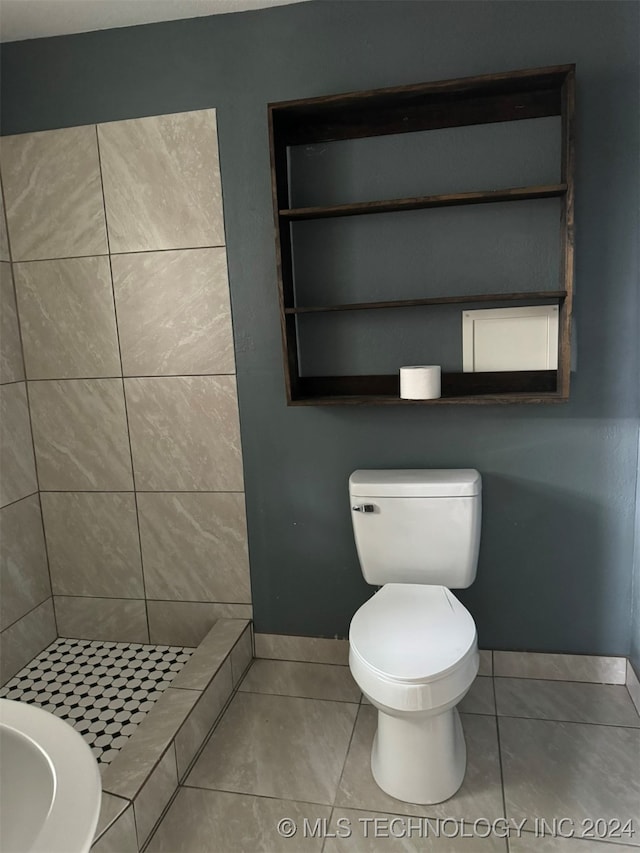 bathroom featuring tile patterned floors, a shower, and toilet