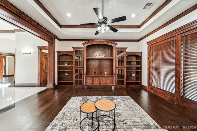 interior space featuring crown molding, ceiling fan, a tray ceiling, and dark hardwood / wood-style flooring