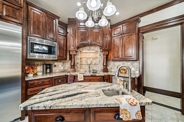 kitchen featuring sink, decorative backsplash, light stone counters, and stainless steel appliances