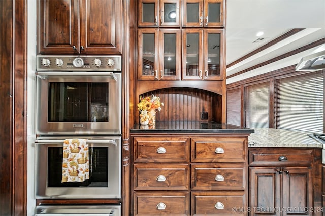 kitchen with double oven and crown molding