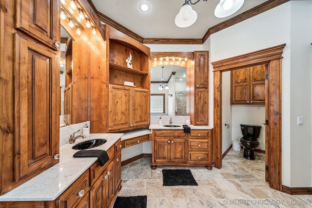 bathroom with vanity, a chandelier, and crown molding