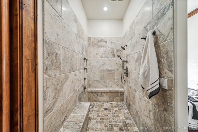 bathroom with tiled shower