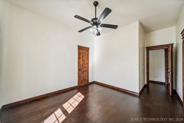 empty room with dark wood-type flooring and ceiling fan