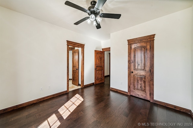 unfurnished room with ceiling fan and dark hardwood / wood-style floors