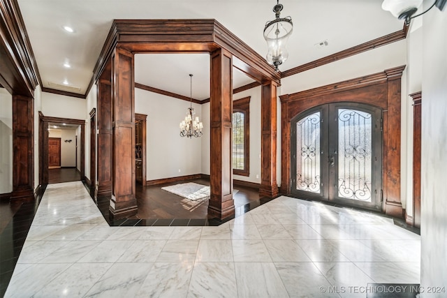 entryway featuring an inviting chandelier, french doors, ornamental molding, and hardwood / wood-style floors