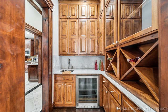 wine area with wet bar, light tile patterned floors, and beverage cooler