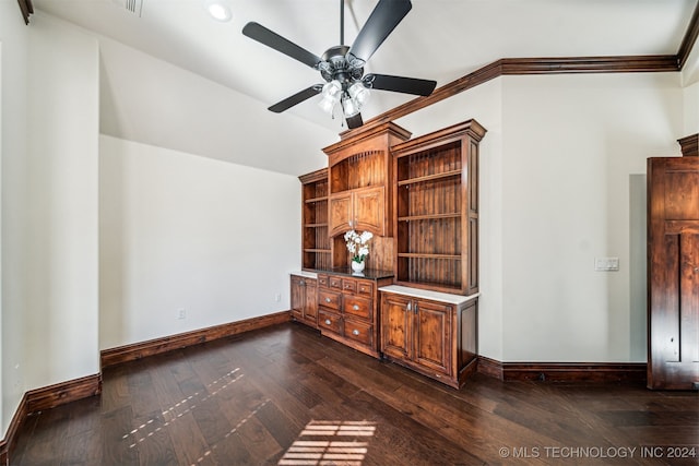 interior space with lofted ceiling, ornamental molding, dark wood-type flooring, and ceiling fan