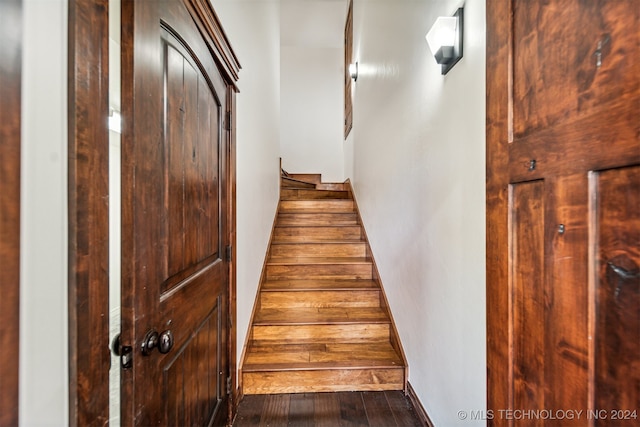 stairs featuring wood-type flooring