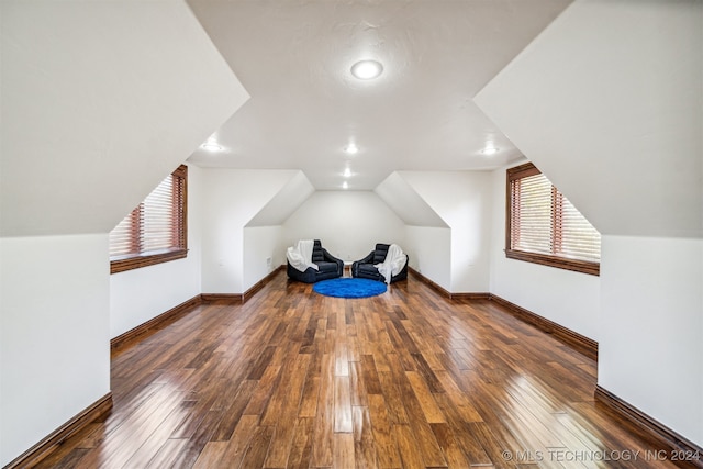 bonus room featuring dark wood-type flooring and vaulted ceiling