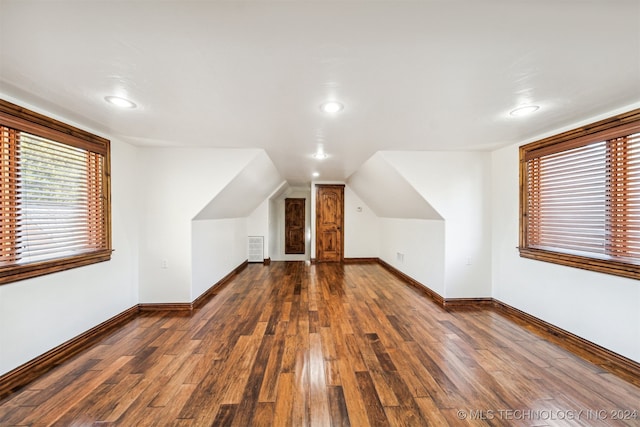 additional living space with lofted ceiling and dark hardwood / wood-style floors