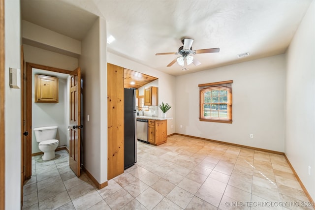 tiled spare room with ceiling fan