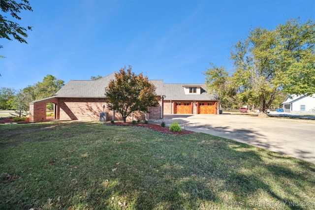 view of front of house with a front yard and a garage