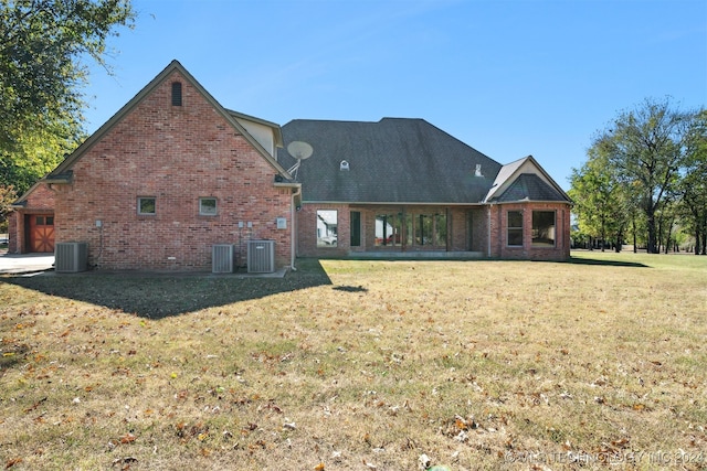 rear view of property with a yard