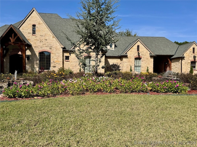 french provincial home with a front lawn