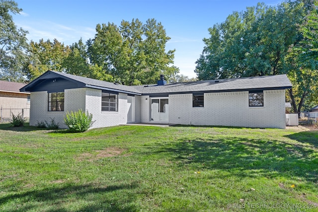 back of property featuring a lawn