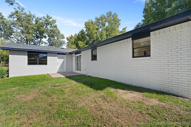 back of house with a lawn