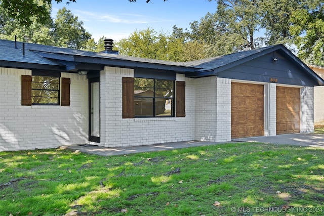 view of front facade with a front lawn and a garage