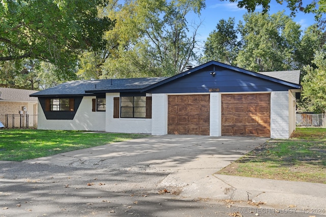 ranch-style house with a garage and a front lawn