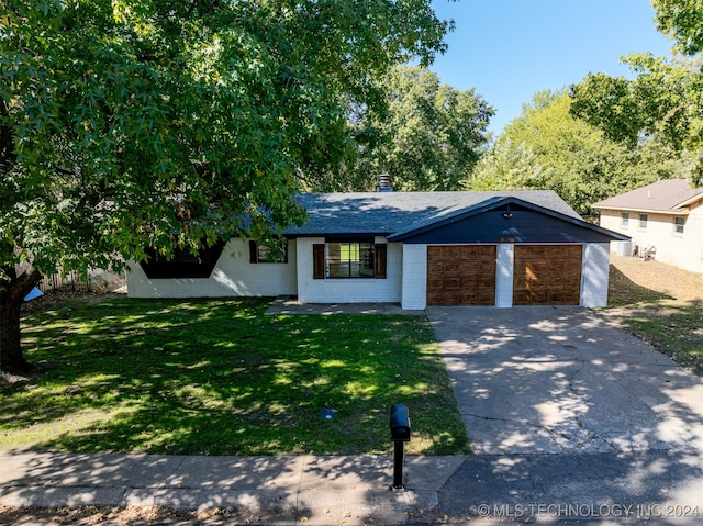 view of front of house featuring a front yard and a garage