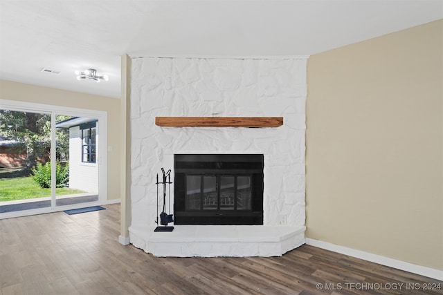 details with hardwood / wood-style flooring and a fireplace