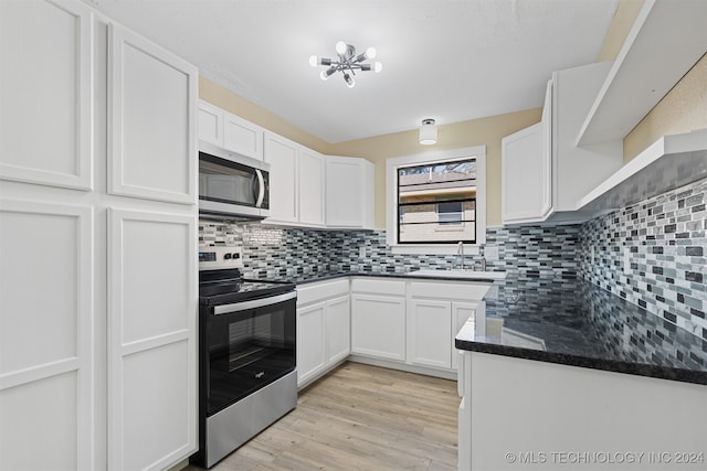 kitchen featuring tasteful backsplash, appliances with stainless steel finishes, light hardwood / wood-style flooring, and white cabinets