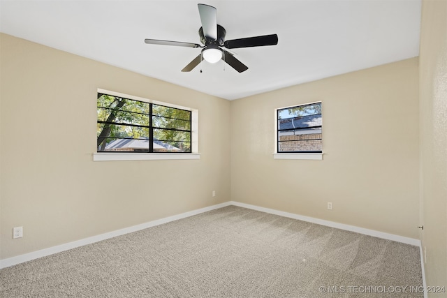 spare room featuring ceiling fan and carpet