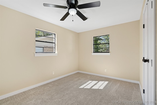 unfurnished room featuring ceiling fan, a healthy amount of sunlight, and light colored carpet