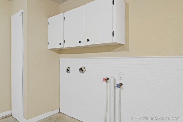 washroom with hookup for an electric dryer and cabinets