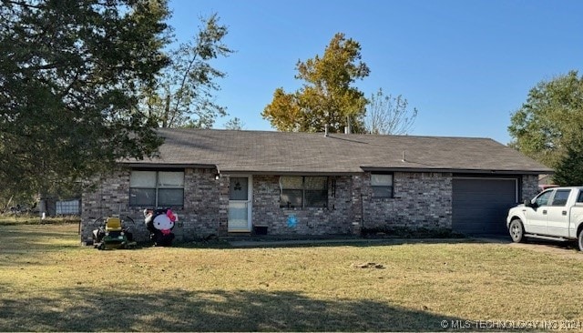 single story home with a front yard and a garage