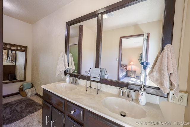 bathroom with vanity and a textured ceiling