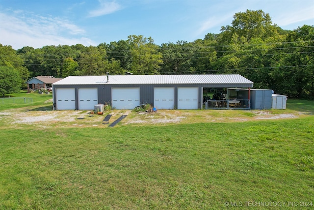 garage featuring central AC and a lawn